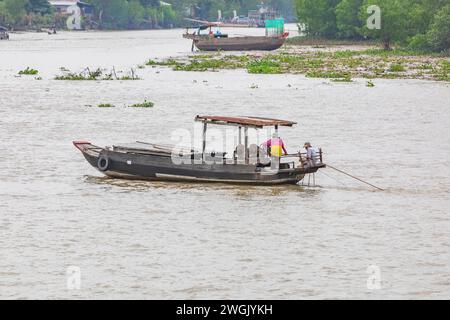 Zwei Männer fischen von einem Boot im Mekong-Delta, Vietnam. Stockfoto