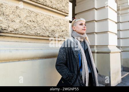 Junge nervöse Frau, die auf der Straße steht und auf ihren Freund oder Freund wartet, der zu spät ist. Hungrige Frau wartet auf eine Begleiterin oder einen Kollegen Stockfoto