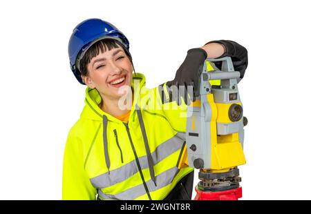 Lächelnde Frau in Schutzhülle und Schutzkleidung Landvermesser mit modernen geodätischen Instrumenten-Tachometer. Frau, die in Konstr. Arbeitet Stockfoto