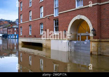 Fluss Ouse platzte Ufer nach starkem Regen (Flussufer unter Wasser, Hochwasser, Gebäude überflutet, Hochwasserbarriere geschlossen) - York, North Yorkshire, England, Großbritannien. Stockfoto