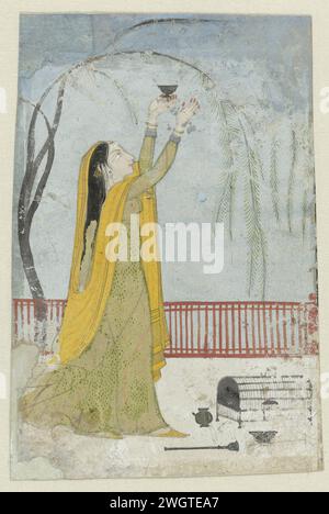 Dame lores Vogel, Anonym, 1810 indische Miniatur. Eine Dame steht auf einer Terrasse, die von einem roten Zaun abgestellt wird; in ihrer erhobenen rechten Hand hält sie eine kleine Schüssel, und ihr ebenfalls erhobener rechter Arm macht Köder auf einen Vogel, der in den Zweigen eines Baumes sitzt; ein Vogelkäfig ist bereit für sie auf dem Boden. Die Show wird von nicht einmal vertikalen und horizontalen orangefarbenen Streifen mit schwarzem Rahmen umrahmt; diese Streifen sind eher fleckig. Kangra hauptsächlich im Schmuck: Papierbürste Stockfoto