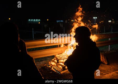 La Fondarella, Lleida, Spanien. Februar 2024. Hunderte katalanischer Bauern und Viehzüchter blockieren den Zugang zur A-2 in La Fondarella, Lleida mit ihren Traktoren und schließen sich den Protesten auf europäischer Ebene im ersten Sektor an. Die Landwirte fordern ein Ende des unlauteren Wettbewerbs für Erzeugnisse, die aus Drittländern eingeführt werden, Unterstützung angesichts überhöhter Preise aufgrund der Auswirkungen der Dürre und Erleichterung der Bürokratie. (Kreditbild: © Marc Asensio Clupes/ZUMA Press Wire) NUR REDAKTIONELLE VERWENDUNG! Nicht für kommerzielle ZWECKE! Stockfoto