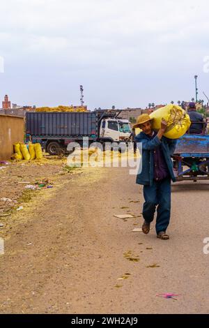 AIT Ourir, Marokko - 04. April 2023: Lokale Marktszene mit Einheimischen, die Waren transportieren, in der Stadt Ait Ourir, Marokko Stockfoto