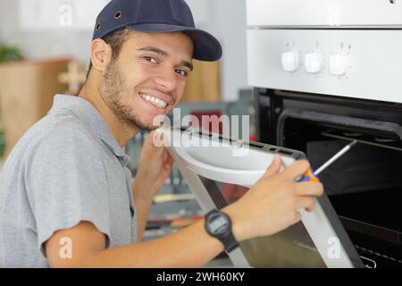 Mann Instandsetzung der heimischen Ofen in der Küche Stockfoto