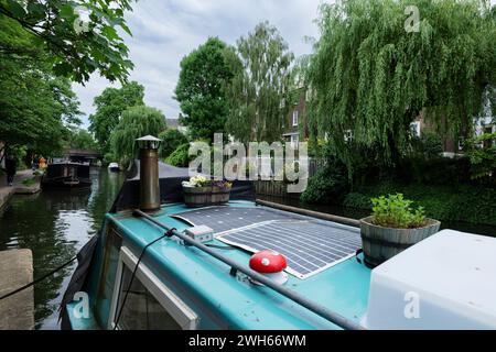 London - 29 05 2022: Im Vordergrund das Dach eines Hausbootes, das auf dem Regent's Canal vertäut ist Stockfoto