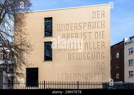 Neuausbau des Hansa-Gymnasiums am Gereonswall, Zitat von Georg Wilhelm Friedrich Hegel an der Fassade, Übersetzung: Widerspruch ist die Wurzel eines Stockfoto