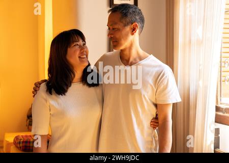 Porträt von japanischen Brüdern und Schwestern umarmen sich, lächeln und schauen sich gegenseitig an. Glückliche Geschwister kümmern sich um einander. Stockfoto