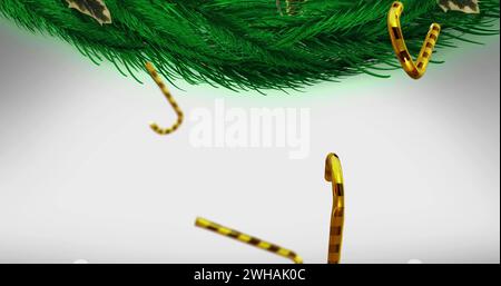 Bild von Bonbonbons weihnachtsdekorationen über Tannenzweigen auf weißem Hintergrund Stockfoto