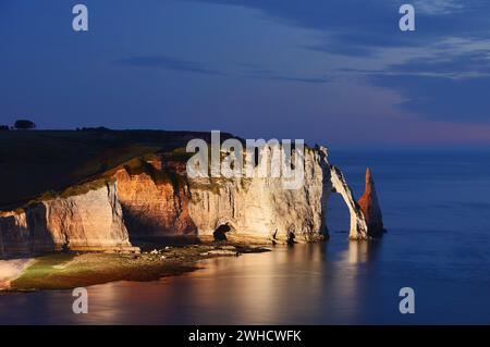 Steile Klippen mit dem Falaise d'Aval Felsentor und der Aiguille díEtretat Felsnadel in der Abenddämmerung, Etretat, Alabasterküste, seine-Maritime, Normandie, Frankreich Stockfoto