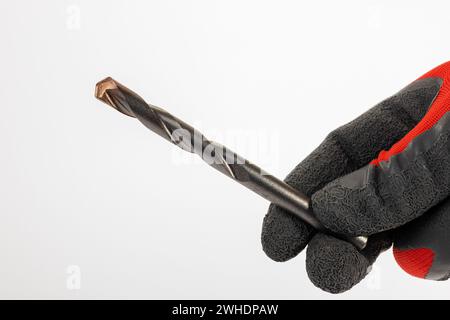 Männerhand mit Arbeitshandschuh, 10 mm Mauerbohrer, weißer Hintergrund, Stockfoto