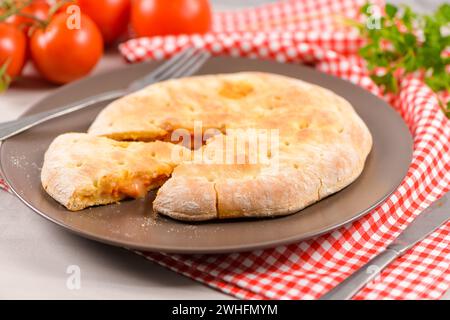 Pizza Calzone auf hölzernem Hintergrund Stockfoto