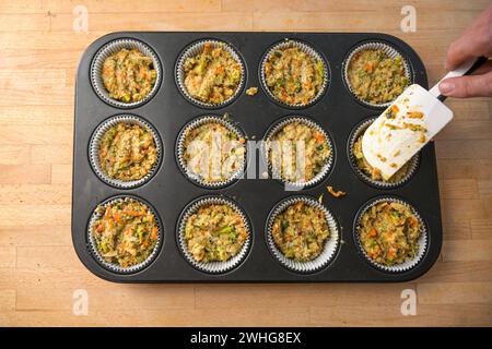 Muffin Backblech gefüllt mit herzhaftem Teig aus Gemüse für gesunde Low Carb Cupcakes, Blick aus dem Hogh-Winkel von oben Stockfoto