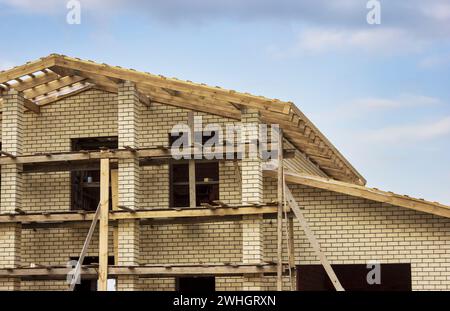 Fragment eines gemauerten Hauses mit Holzdach Stockfoto