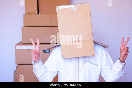 Ein arabischer Mann, der einen Karton auf den Kopf legt Stockfoto