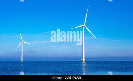 Windmühlenpark mit Wolken und blauem Himmel, Windmühlenpark mit Blick auf das Meer aus der Luft Stockfoto