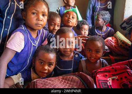 Fröhliche madagassische Schulkinder im Klassenzimmer. Der Schulbesuch ist obligatorisch, aber viele Kinder gehen nicht zur Schule. Stockfoto