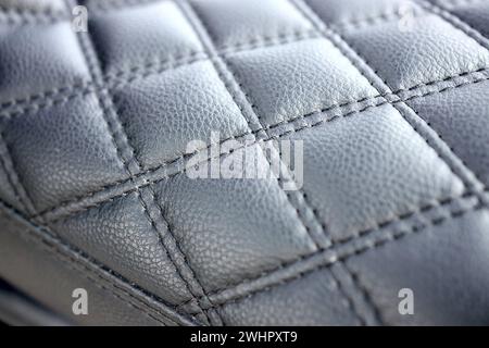 Motorradsitz aus schwarzem Leder mit natürlicher Steppnaht und selektivem Fokus. Stockfoto