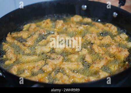 Das knusprige Fleisch wird im Eisentopf gebraten. Frittierter Schweinebauch，Sichuan-Snacks Stockfoto