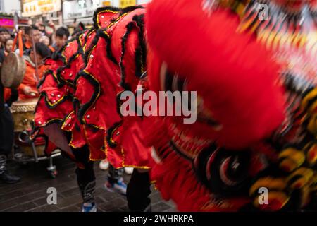 Menschenmassen versammeln sich um einen Drachentänzer in China Town, London. Tausende feiern das chinesische Neujahr, das Jahr des Drachen. Stockfoto