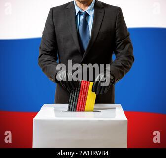 Mann mit Handschuh wirft deutsche Flagge in die Sprechbox Stockfoto