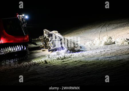 Die Schneeratrak (Sau Cat) passt die Piste für das Skifahren in der Nacht an. Stockfoto