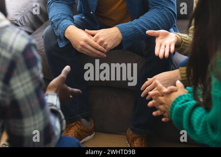 Hände verschiedener Gruppen von Freunden, die sich bei der Therapiesitzung unterhalten und unterstützen Stockfoto