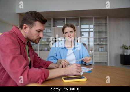 Die Frau, die überrascht ist, wenn sie Rechnungen für Casino und Online-Spiele erhalten hat, muss vom Ehemann erklärt werden Stockfoto