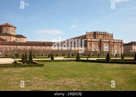 VENARIA REALE, ITALIEN - 29. MÄRZ 2023: Architektur und Park der Burg Reggia di Venaria mit pyramidalen Hecken im Frühlingssonnenlicht Stockfoto