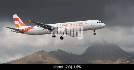 Teneriffa, Spanien 11. Februar 2024. Airbus A321-211 Sunclass Airlines fliegt in den dunklen Wolken. Landet am Flughafen Teneriffa Stockfoto
