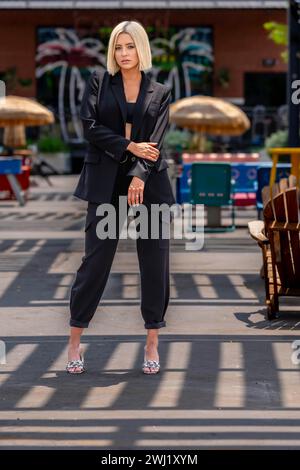 Ein schönes blondes Model posiert im Freien und genießt das Frühlingswetter Stockfoto