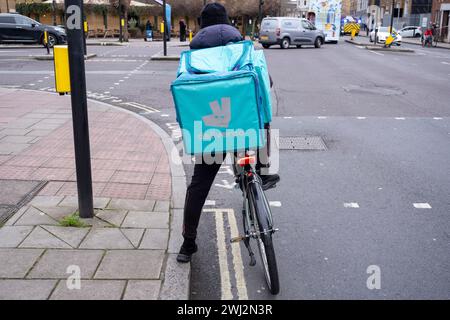 Deliveroo Lieferzyklus Kurier zum Mitnehmen am 7. Februar 2024 in London, Großbritannien. Deliveroo fungiert als Vermittler zwischen unabhängigen Lebensmittelgeschäften und Kunden, wobei Tausende von Fahrradkurieren Lebensmittel per Fahrrad und andere Transportmittel liefern. Gig-Arbeitnehmer sind unabhängige Auftragnehmer, Online-Plattform-Mitarbeiter, Vertragsarbeiter, Bereitschaftsarbeiter und Leiharbeiter. Gig-Arbeitnehmer schließen förmliche Vereinbarungen mit On-Demand-Unternehmen über die Erbringung von Dienstleistungen für die Kunden des Unternehmens. Stockfoto