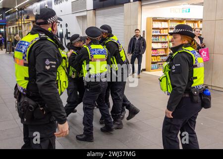 Leeds, Großbritannien. FEBRUAR 2024. Der Mann wird aus der Sichtbarkeit des palästinensischen Protestes im Bahnhof Leeds entfernt, bevor er sich widersetzt und inhaftiert wird. Der Mann schrie zu den Pro-palästina-Demonstranten und wurde trotz wiederholter Warnungen schließlich gewaltsam von BTP- und West Yorkshire-Polizisten festgenommen, nachdem sie versuchten, ihn aus dem Gebäude zu entfernen, als Teil der unzulässigen Verhaltensregeln der Stationen. Credit Milo Chandler/Alamy Live News Stockfoto