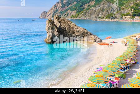 Kieselstrand Monterosso Urlaubsliegen und Sonnenschirme am Strand von Cinque Terre Italien. Stockfoto