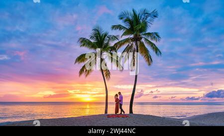 Paare am Strand mit Palmen Sonnenuntergang am tropischen Strand von Saint Lucia oder St. Lucia Caribbean Stockfoto