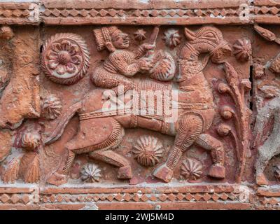 Nahaufnahme der geschnitzten Terrakotta-Szene eines Mannes, der auf dem alten Govinda-Tempel im religiösen Komplex Puthia, Rajshahi, Bangladesch reitet Stockfoto