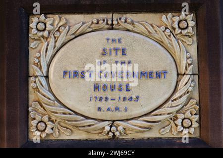 Glasierte Keramikplatte mit Blumenemblemen in jeder Ecke, die an den Ort des ersten Regierungsgebäudes von 1788 bis 1845 in der Phillip St, Sydney, erinnert Stockfoto