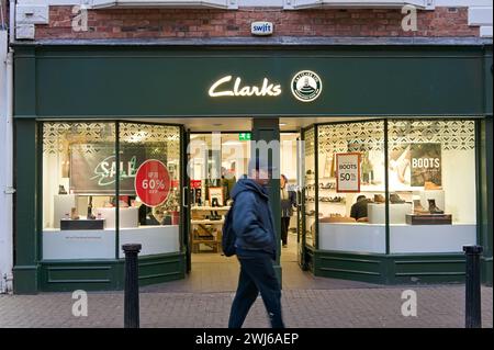 Clarks Schuhgeschäft mit einer bewegungsunscharfen Person, die auf der High Street in Lincoln vorbeiläuft. Lincolnshire, Stockfoto