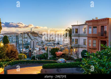 Die krummste Straße der Welt Lombard Street. San Francisco wird von der Morgensonne erhellt. Blick vom Gipfel der berühmten Straße. Stockfoto