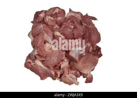 In Stücke geschnittenes Schweinefleisch liegt auf einem Haufen auf weißem Hintergrund. Stockfoto
