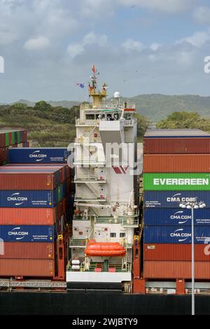 Colon, Panama - 22. Januar 2024: Schiffscontainer stapelten sich entlang der Brücke auf einem Schiff, das die Schleusen der Agua Clara auf dem Panamakanal durchquerte Stockfoto