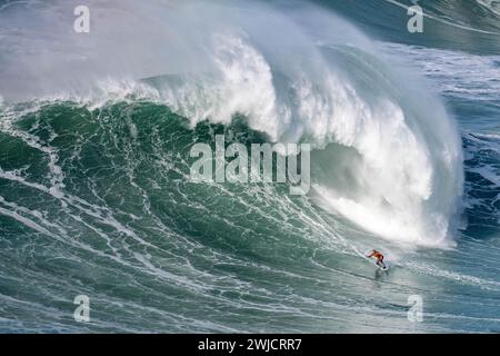 Ein Surfer reitet auf einer stürzenden Welle, Nazare, Portugal Stockfoto