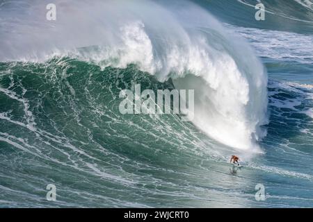 Ein Surfer reitet auf einer stürzenden Welle, Nazare, Portugal Stockfoto