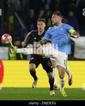 Rom. Februar 2024. Bayern Münchner Joshua Kimmich (L) streitet mit Lazios Ciro immobile während des 1. Leg-Spiels der UEFA Champions League zwischen Latium und Bayern München am 14. Februar 2024 in Rom. Quelle: Augusto Casasoli/Xinhua/Alamy Live News Stockfoto