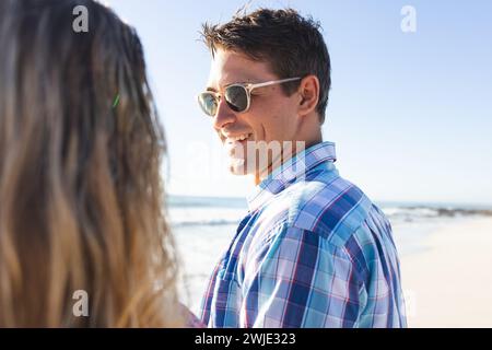 Das kaukasische Paar genießt einen sonnigen Strandtag Stockfoto