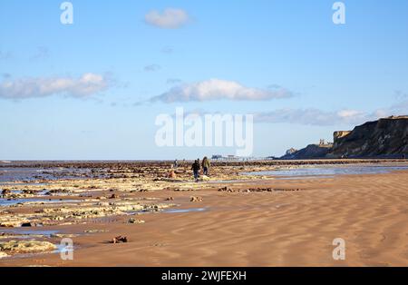 Ein Blick nach Osten entlang der Küste mit Menschen, Sand und Kreidefelsen am Strand von West Runton, Norfolk, England, Großbritannien. Stockfoto