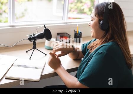 Die junge Frau nimmt einen Podcast von zu Hause auf Stockfoto