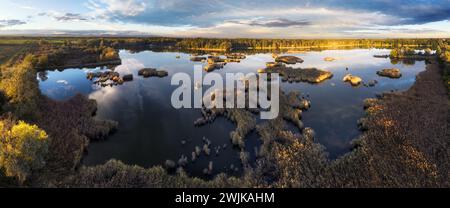 Ein Drohnenfoto des Sees - Teichmoor mit Sonne - absolut atemberaubendes Panorama des Sonnenuntergangs aus der Luft. Stockfoto