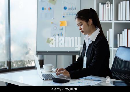 Geschäftsfrau übergibt mit einem Rechner die Finanzen, die Einnahmen und das Budget des Unternehmens Stockfoto