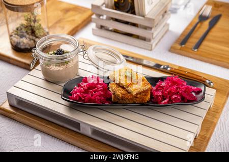 Hausgemachte Mangalitza-Leberpastete in einem Glas, serviert mit Sauerteigtoast und saurem Rotkohl Stockfoto