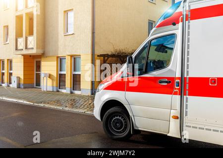 Deutscher Krankenwagen EMS Sanitäter-Rettungswagen-Transport parkt am sonnigen Tag nach Regen auf der europäischen Stadtstraße. Ärztlicher Eildienst Stockfoto